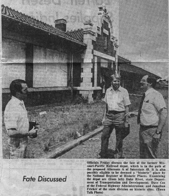 Officials discuss the fate of the former Missouri-Pacific Railroad depot, which is in the path of the proposed Alternate A route of Interstate 49. It is also possibly eligible to be deemed a "historic" place by the National Register of Historic Places. Examining the depot are (from left) Duke Rivet, State Department of Transportation & Development (DOTD), Dave Cox of the Federal Highway Administration, and Jonathan Fricker of the state division on historic sites.